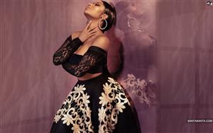 Nicki Minaj fascinatingly posing in a hot black and white dress